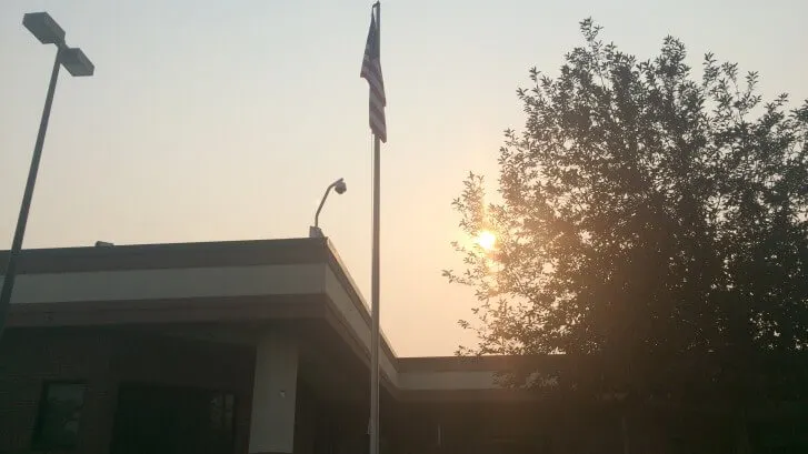 Sunrise behind a tree above the hospital roof