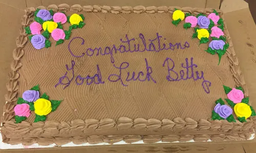 Sheet cake iced with Congratulations, Good Luck Betty
