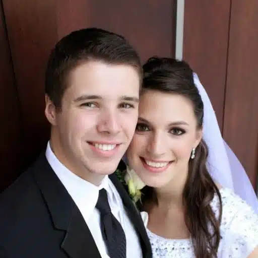 Newly married couple posed together in wedding attire
