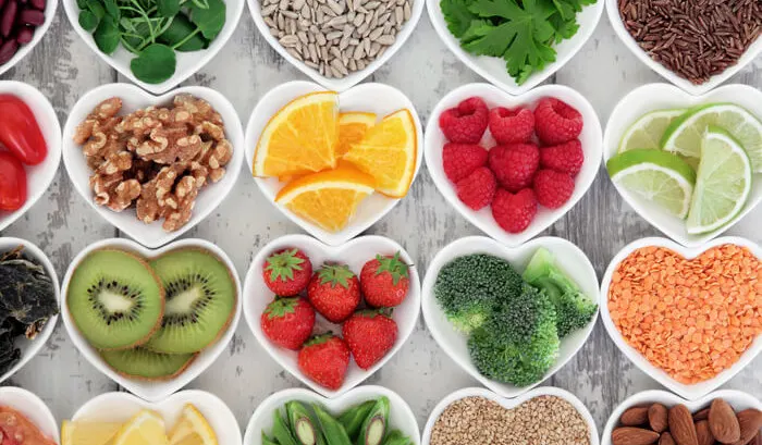 Heart-shaped dishes of fruit, nuts, seeds and vegetables