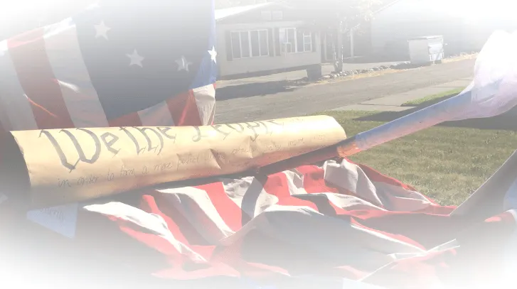 Rolled document resting on an American flag outdoors