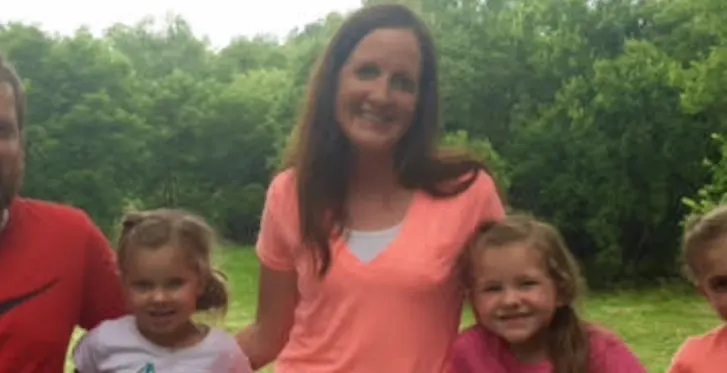 Madisonhealth staff member in a coral top with her children outdoors