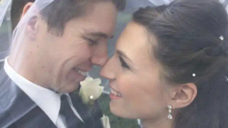 Bride and groom smiling close together on their wedding day