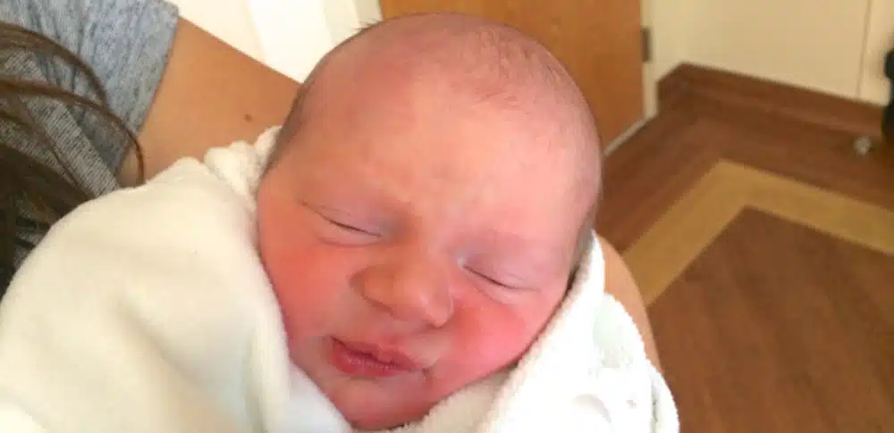 Newborn wrapped in a white blanket
