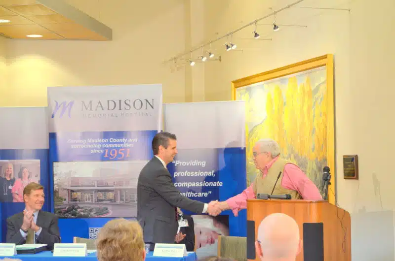 Hospital leaders shaking hands at a Madison Memorial event