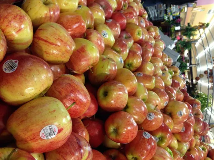 Pile of apples on display at a grocery store