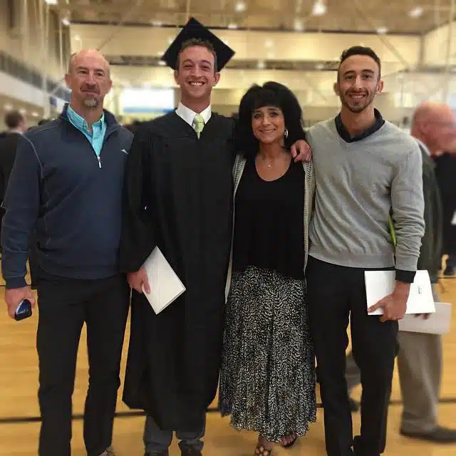 Family posed with a graduate in cap and gown