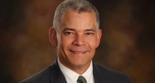 Madisonhealth staff portrait: man with grey hair in a dark suit and tie