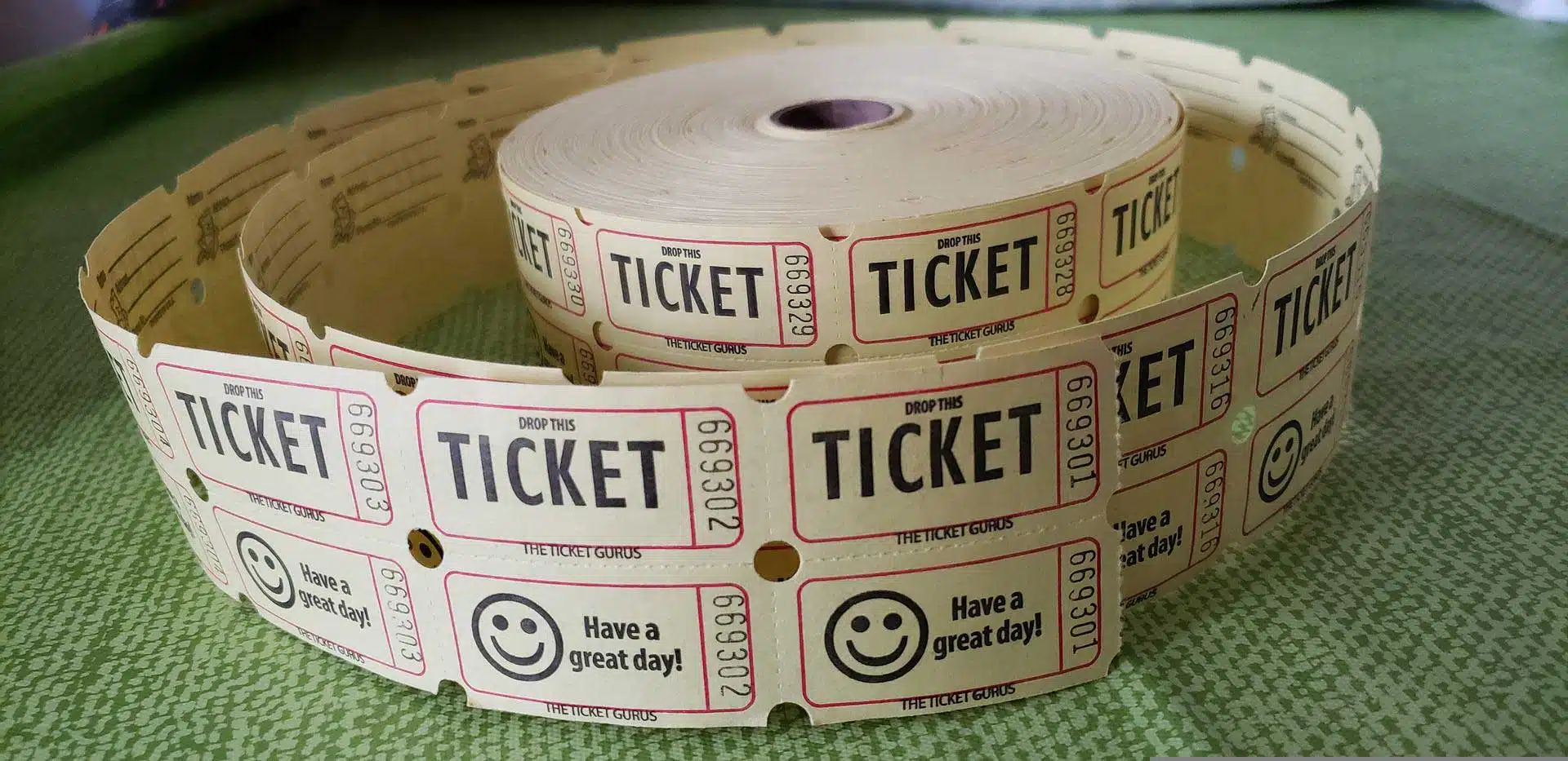 Roll of raffle tickets on a green tablecloth