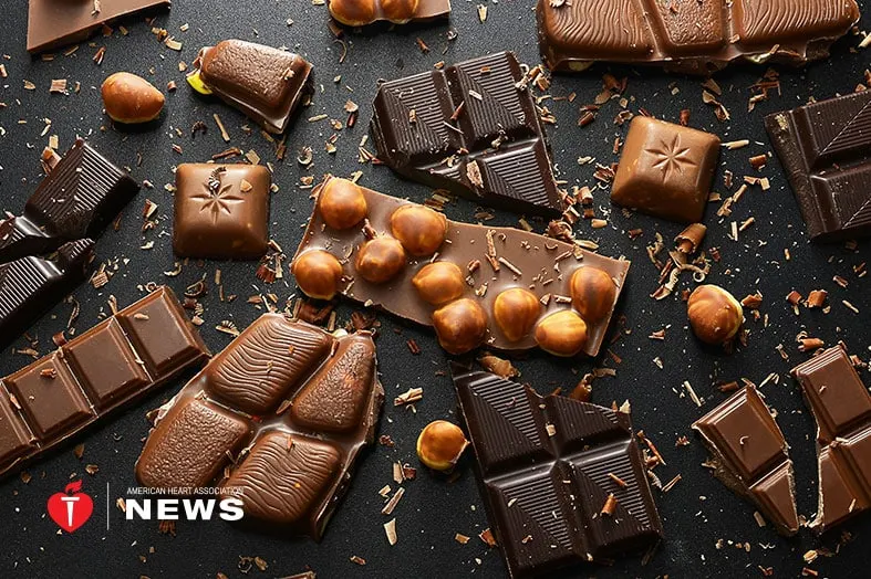 Assorted chocolate bars and pieces on a dark surface