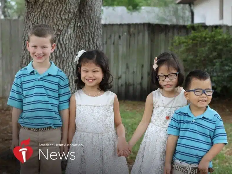 Four children holding hands in a yard, from American Heart Association News