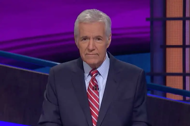 Game show host standing on a brightly lit television set