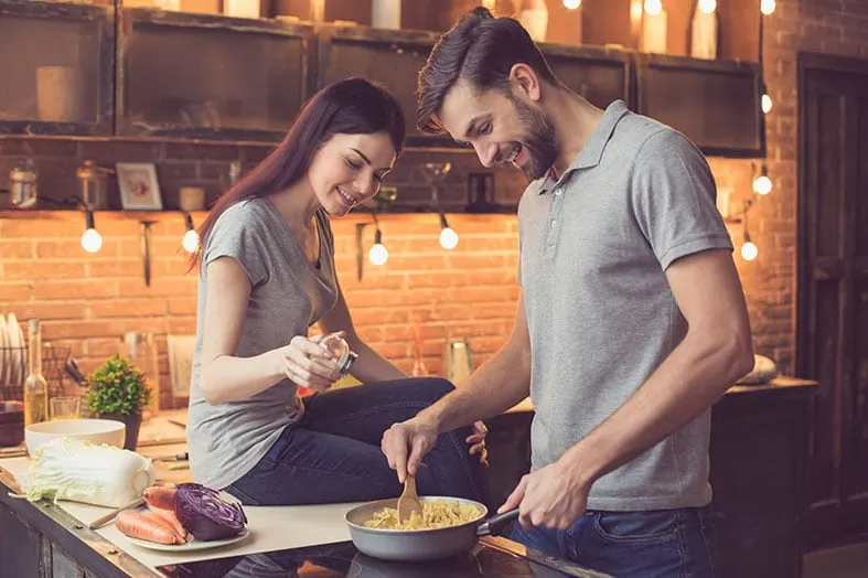 Couple cooking a meal together in a kitchen