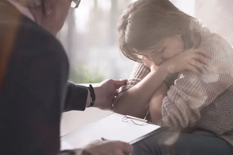 Clinician drawing a blood sample from a patient's arm