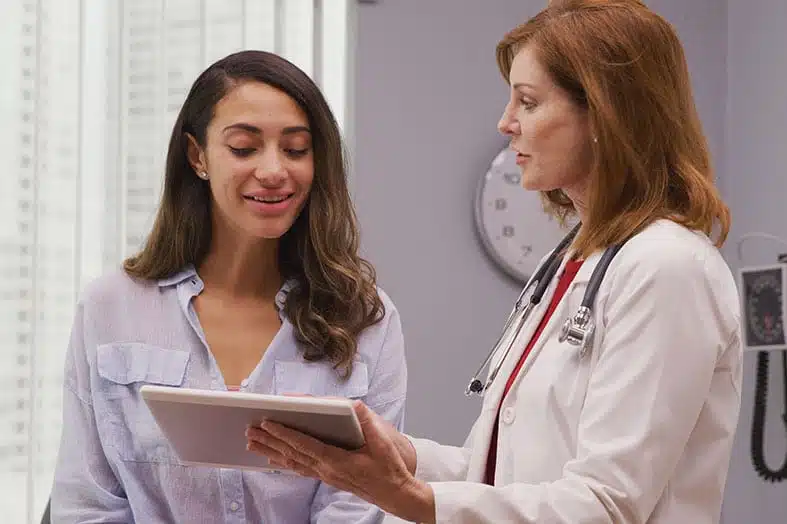 Doctor showing a patient information on a tablet