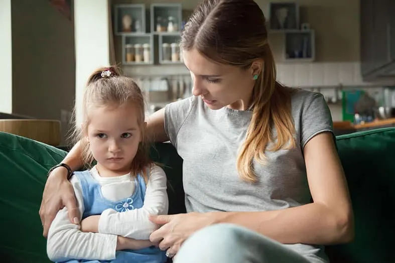 Mother comforting her daughter whose arm is in a cast