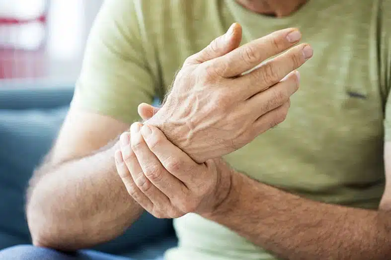 Man holding his wrist and hand in pain