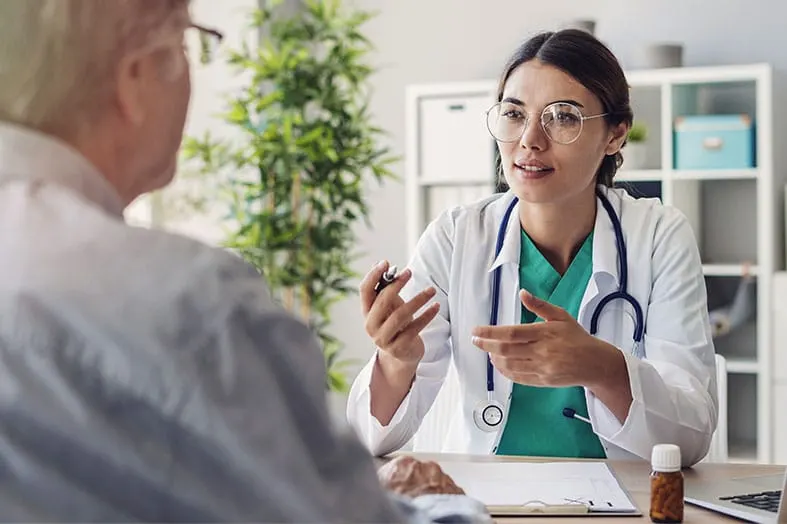Doctor explaining a prescription to an older patient