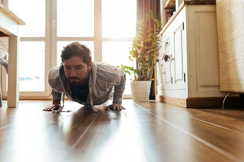 Man doing a push-up on the floor at home
