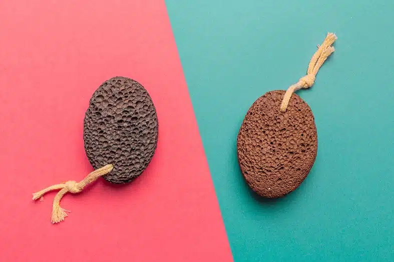 Two pumice stones on a pink and teal background