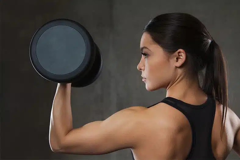 Woman lifting a dumbbell during a strength training workout