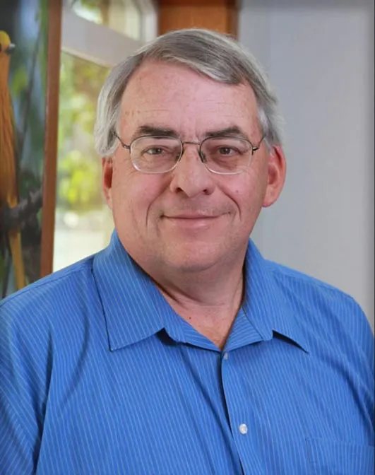 Madisonhealth staff portrait: older man with glasses in a blue shirt