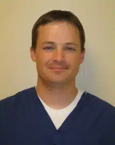 Madisonhealth provider portrait: man in navy scrubs
