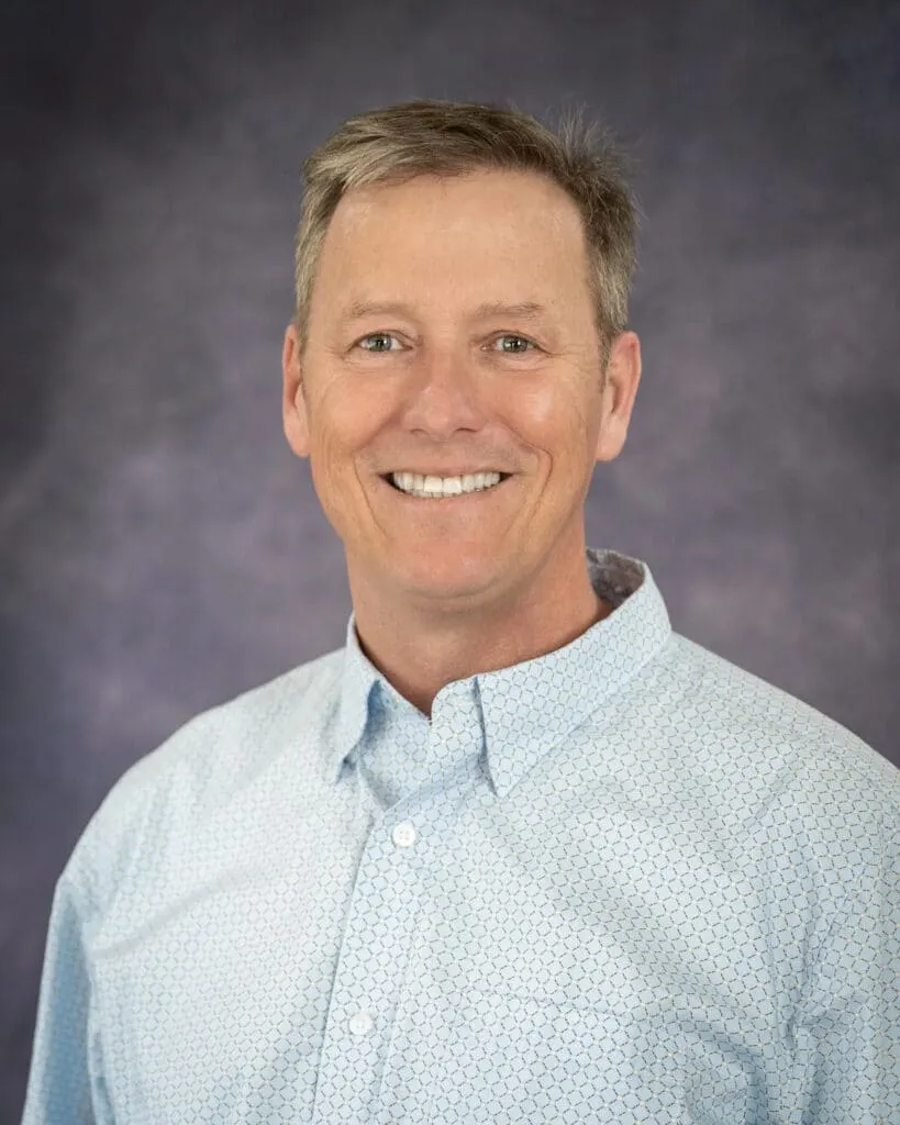 Madisonhealth staff portrait: man with grey hair in a light blue button-down