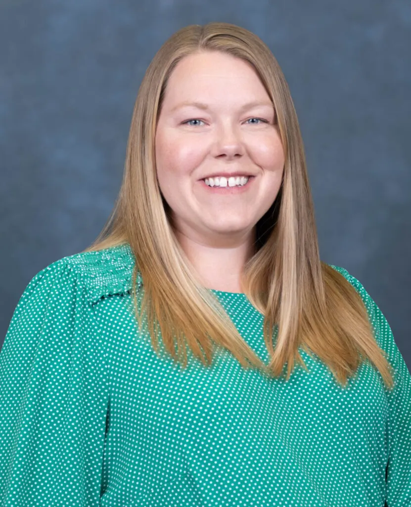 Madisonhealth staff portrait: woman with long blonde hair in a green patterned blouse
