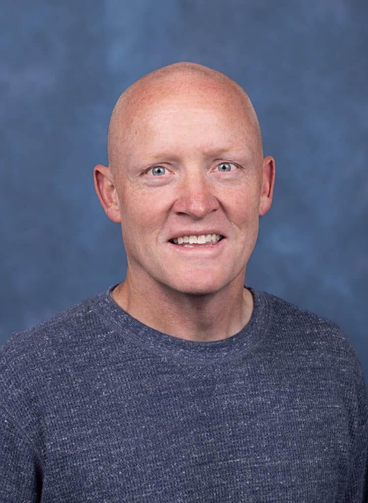 OB/GYN Physician portrait with blue background
