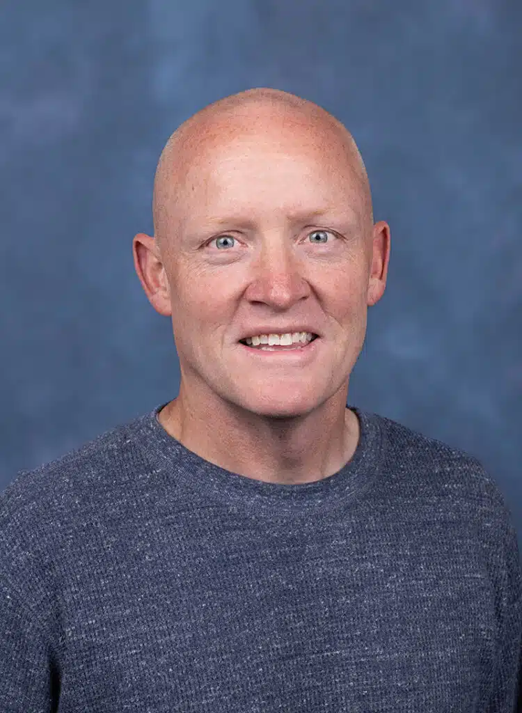 OB/GYN Physician portrait with blue background