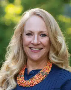 Madisonhealth staff portrait: woman in a navy top with a beaded necklace