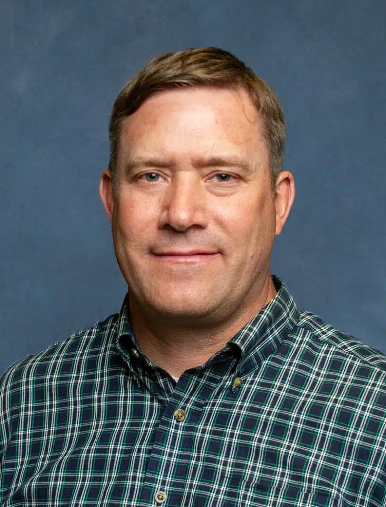 Orthopedic surgeon portrait on blue background