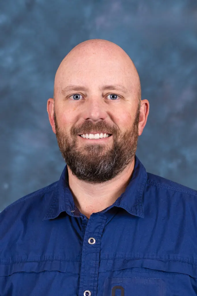 Madisonhealth staff portrait: bearded man in a navy button-down shirt
