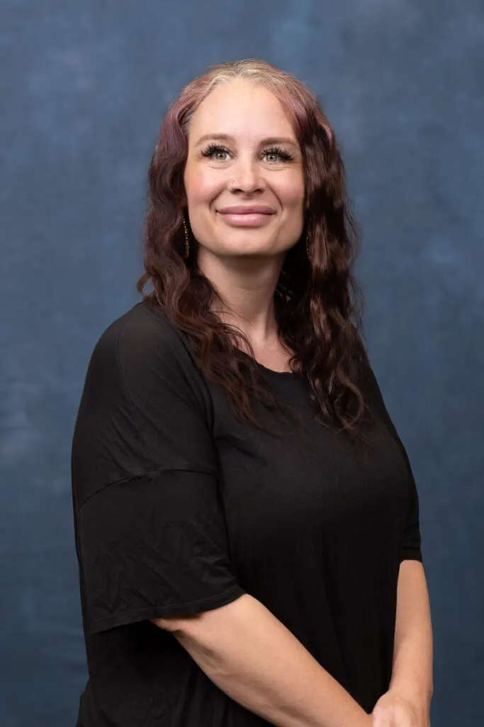 Madisonhealth staff portrait: woman with long auburn hair in a black top