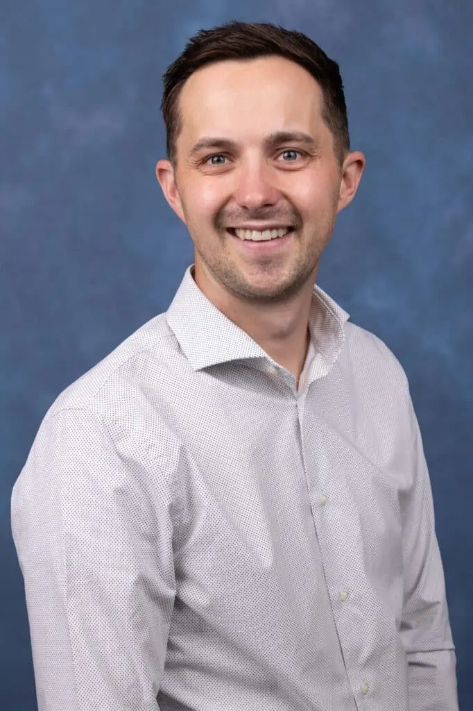 Madisonhealth staff portrait: man in a light grey button-down shirt