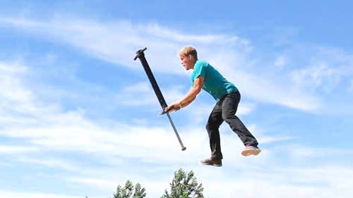 a man jumping on a pogo stick