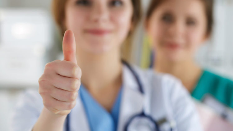 Female doctor giving a thumbs up