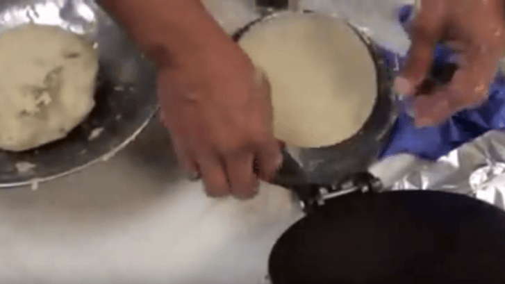 a tortilla being made