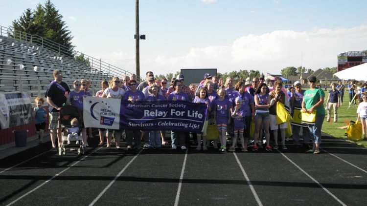 relay for life team standing with sign